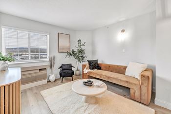 a living room with a couch and a coffee table at The Meriden, 06450